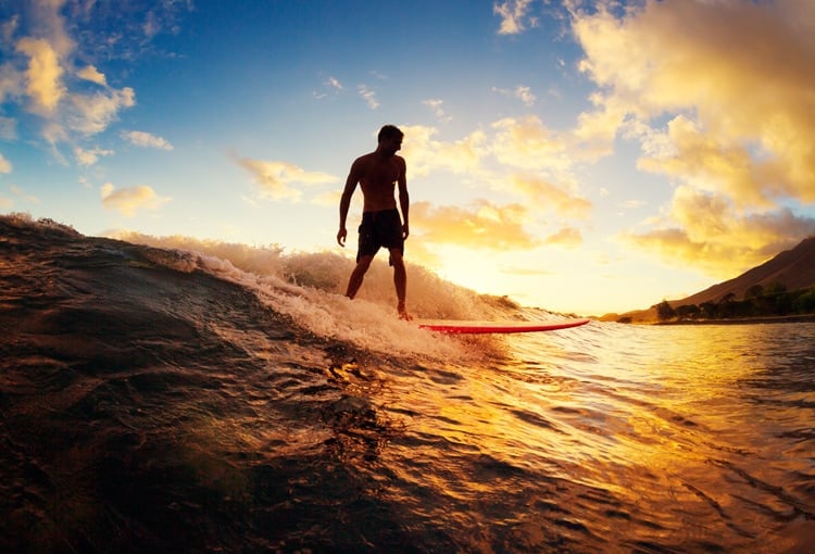 Surfing in Oceania at sunset