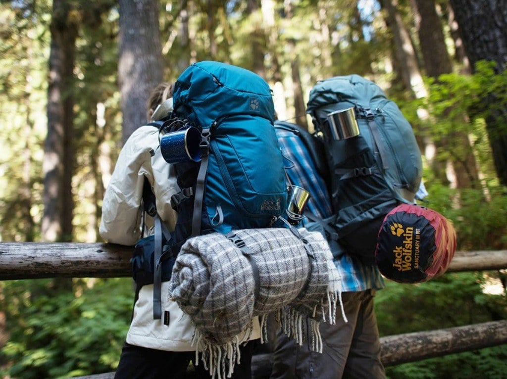 Two travellers with their used backpacking gear setup