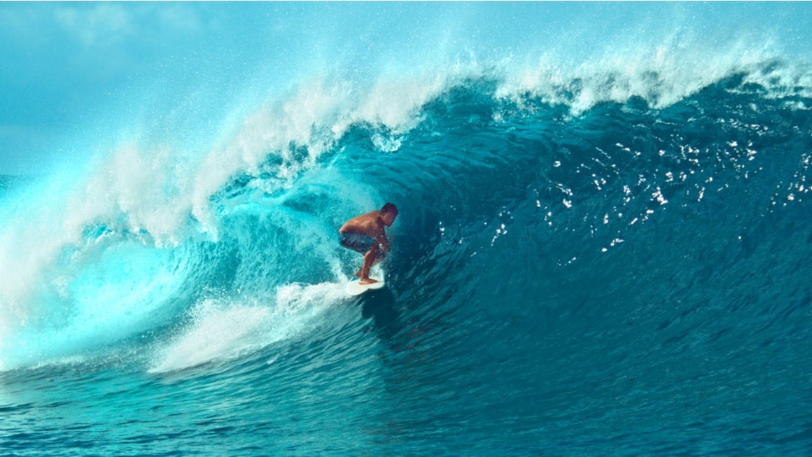 A surfer in the barrel of a wave in french polynesia