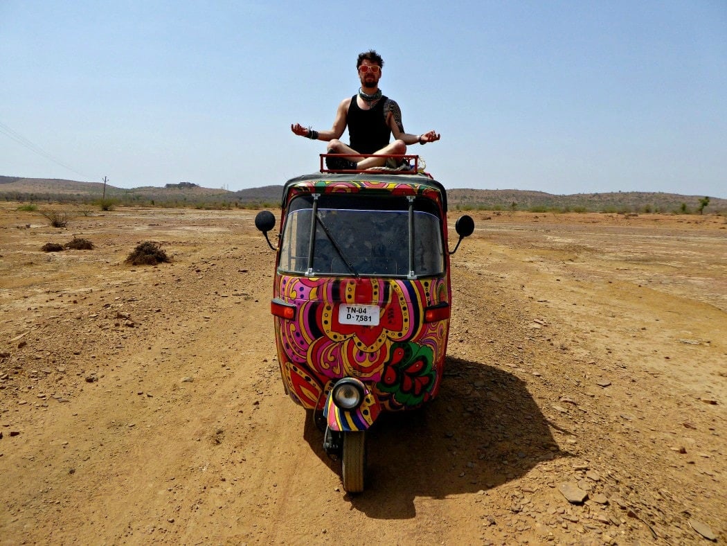 will on top of a colorful rickshaw in india